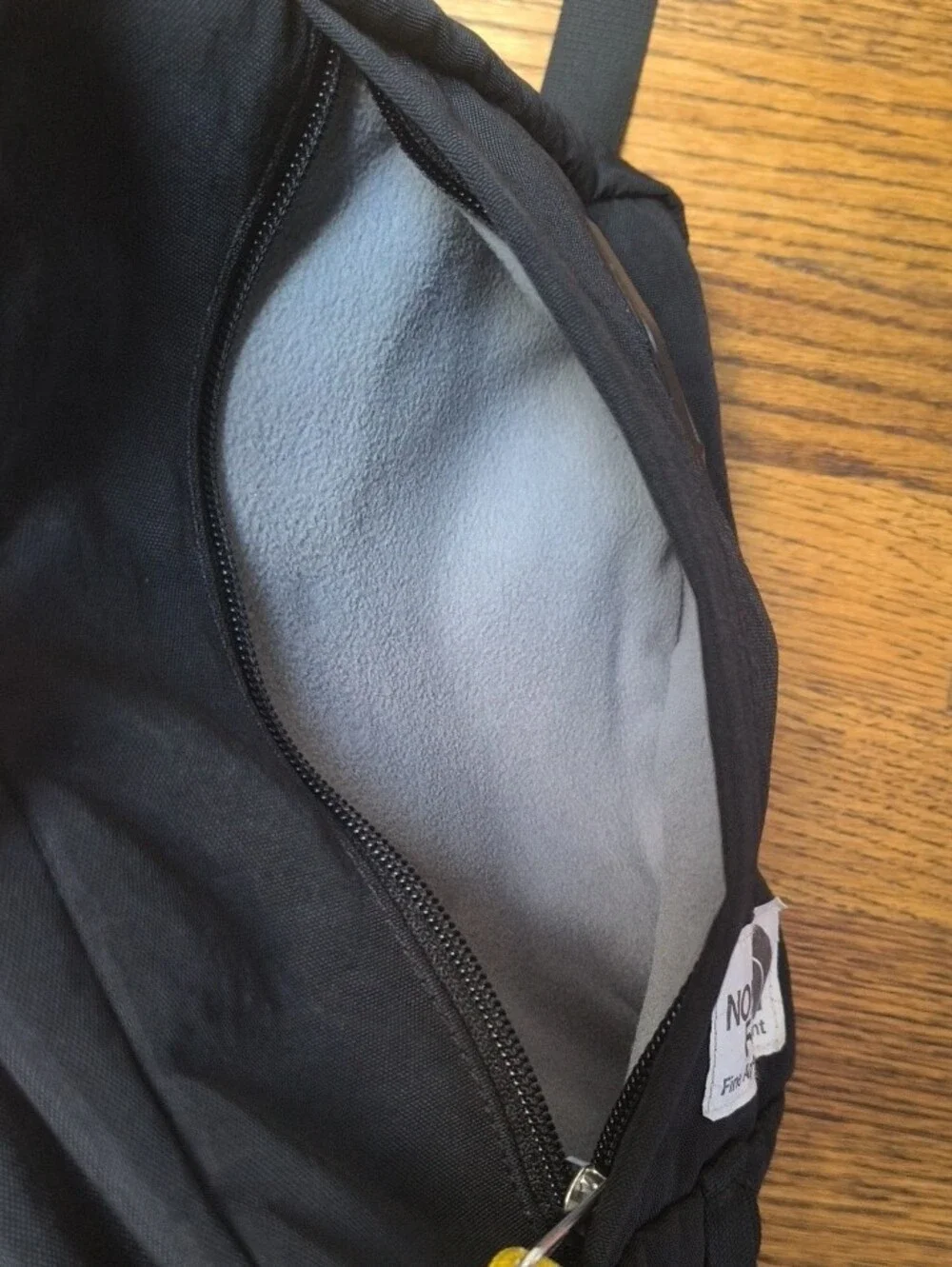 The North Face Black Crossbody Pack with Yellow Cord Pulls